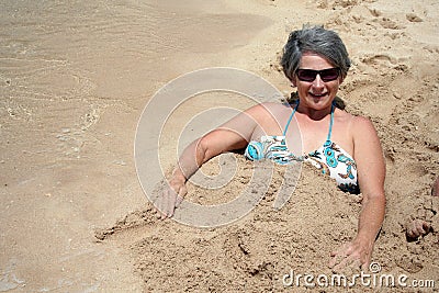 woman-buried-sand-5253724.jpg